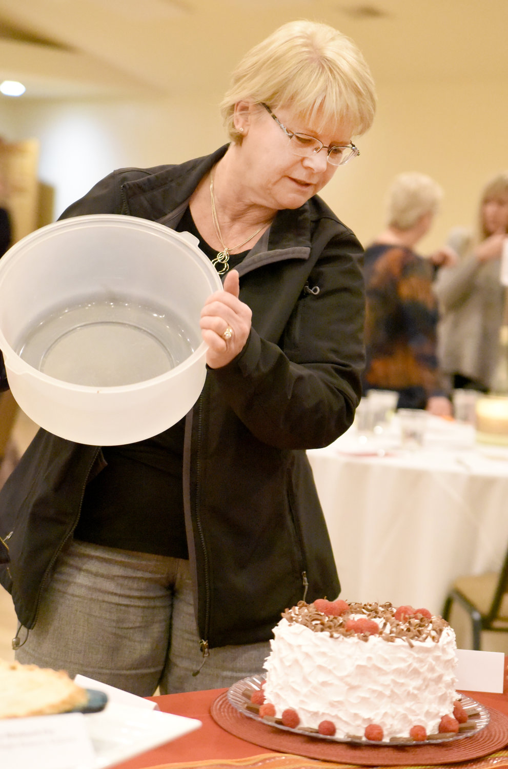 Lois Kasdorf reveals her Chocolate Angel Food Cake at the Washington County Community Foundation’s Chef Spotlight dinner on Nov. 4. The desserts, auctioned off by Dwight Duwa of Duwa’s Auction Service, benefitted both the foundation and the Kalona Historical Village.